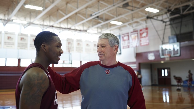 A basketball coach talks to his student-athlete during team practice. 
