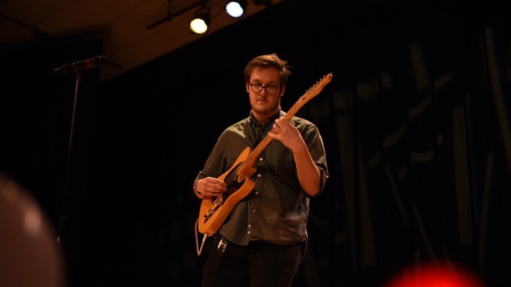 A student playing the guitar at the Fall Music Festival.