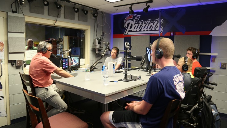 Students and a professor in the radio studio in Gillette Stadium receive hands-on experience broadcasting for the New England Patriots. 