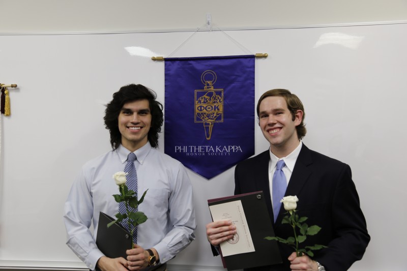 image of two students standing in front of banner during Phi Theta Kappa Honor Society event.